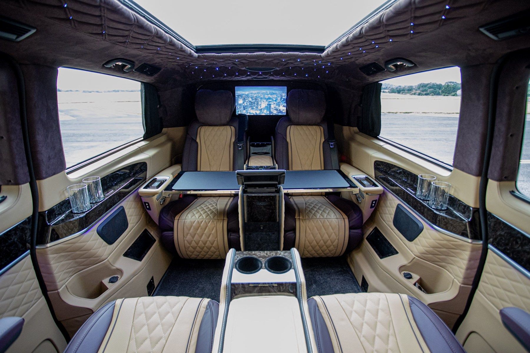 Jet Class cabin with four lounge chairs facing each other around a polished wood table