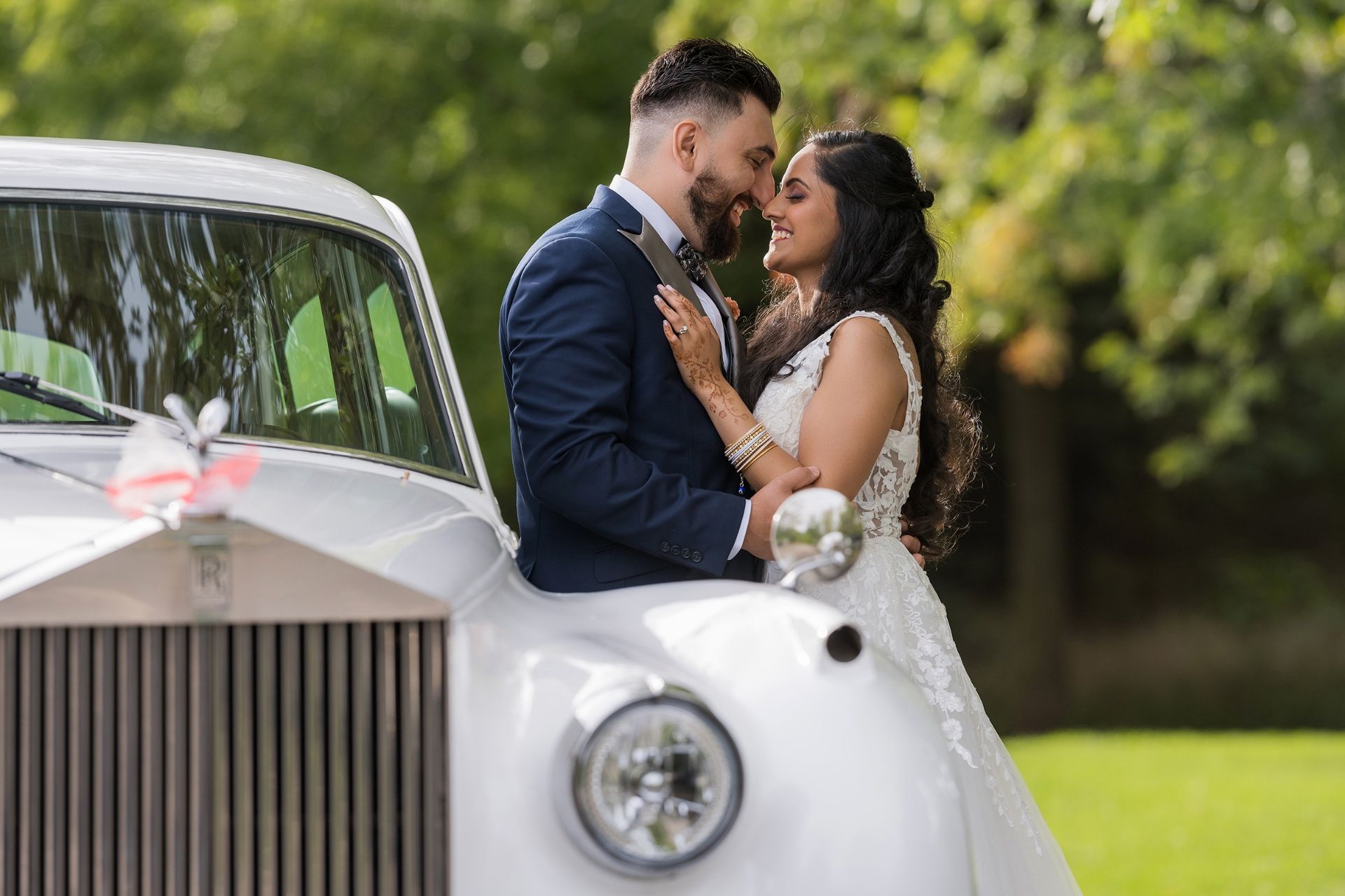 White Rolls-Royce wedding car outside an English church