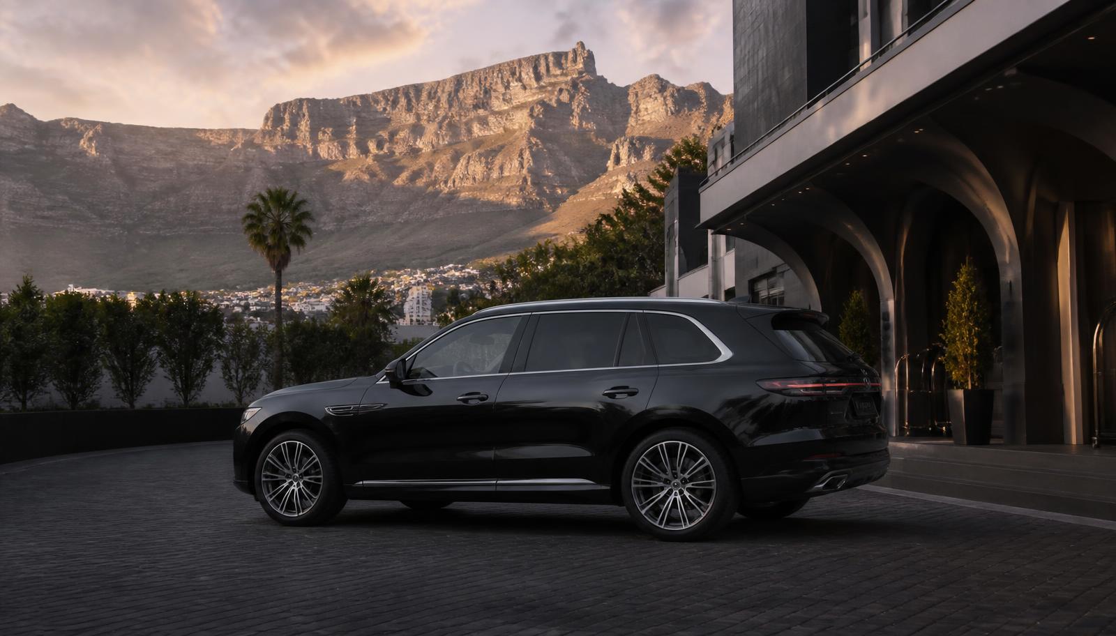 Black luxury chauffeur vehicle at a Cape Town hotel beneath Table Mountain